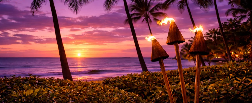 Tiki torches above the ocean at sunset